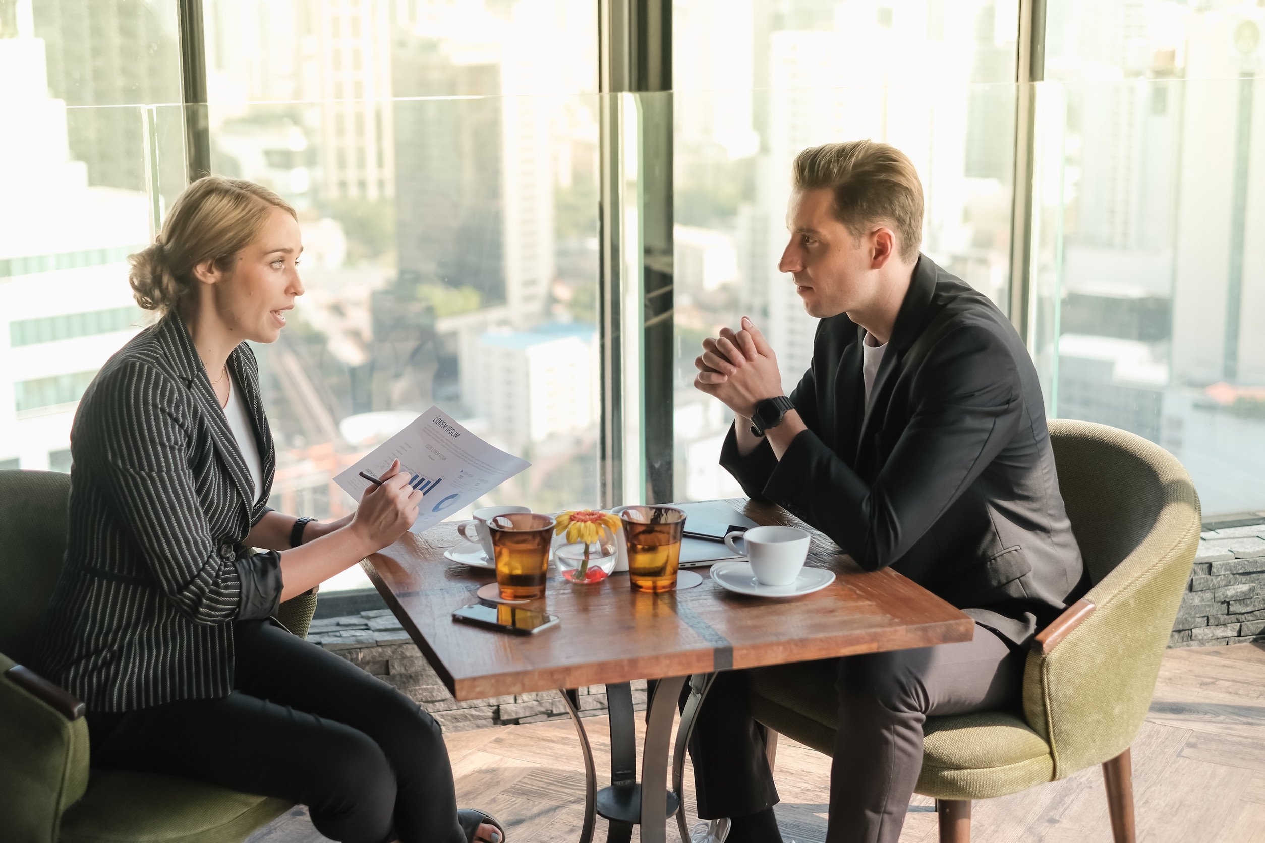 One businessperson talking, and another actively listening in a casual setting
